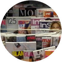 Magazine rack with lots of magazines in them: Art Public Relations Firm